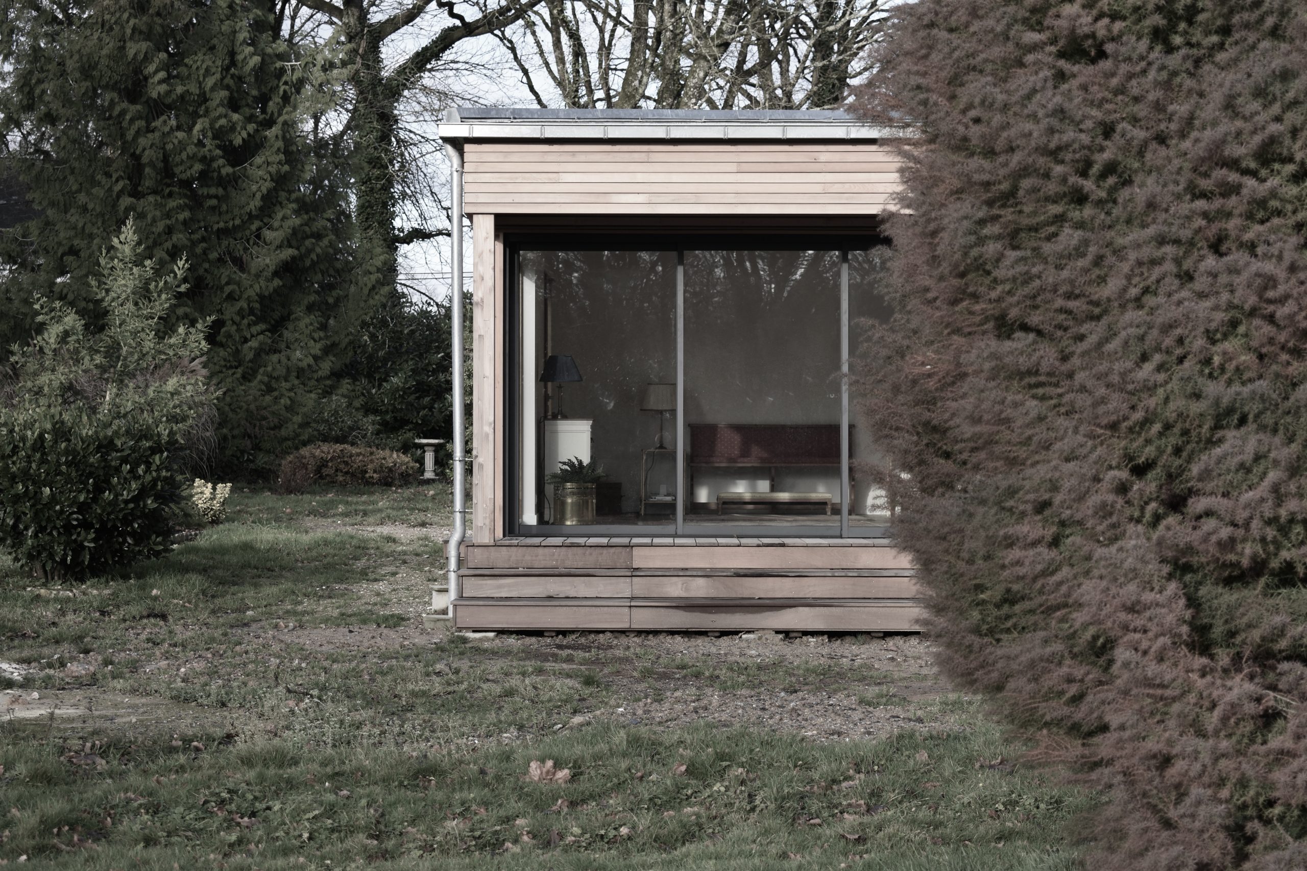 Timber frame extension with extensive glazing opening up the existing building to the garden. Clad in Western Red Cedar with standing seam zinc roof.